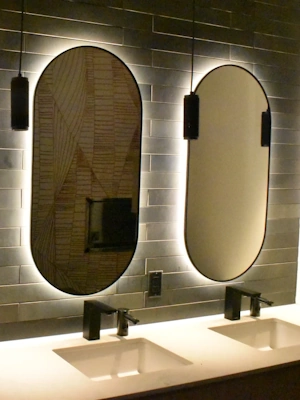 Decorative oval vanity mirrors in a hotel bathroom
