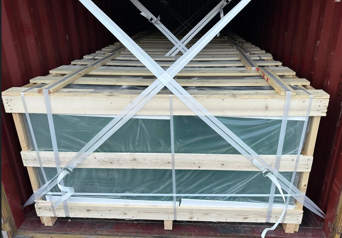 Glass sheets secured in a shipping rack for transport
