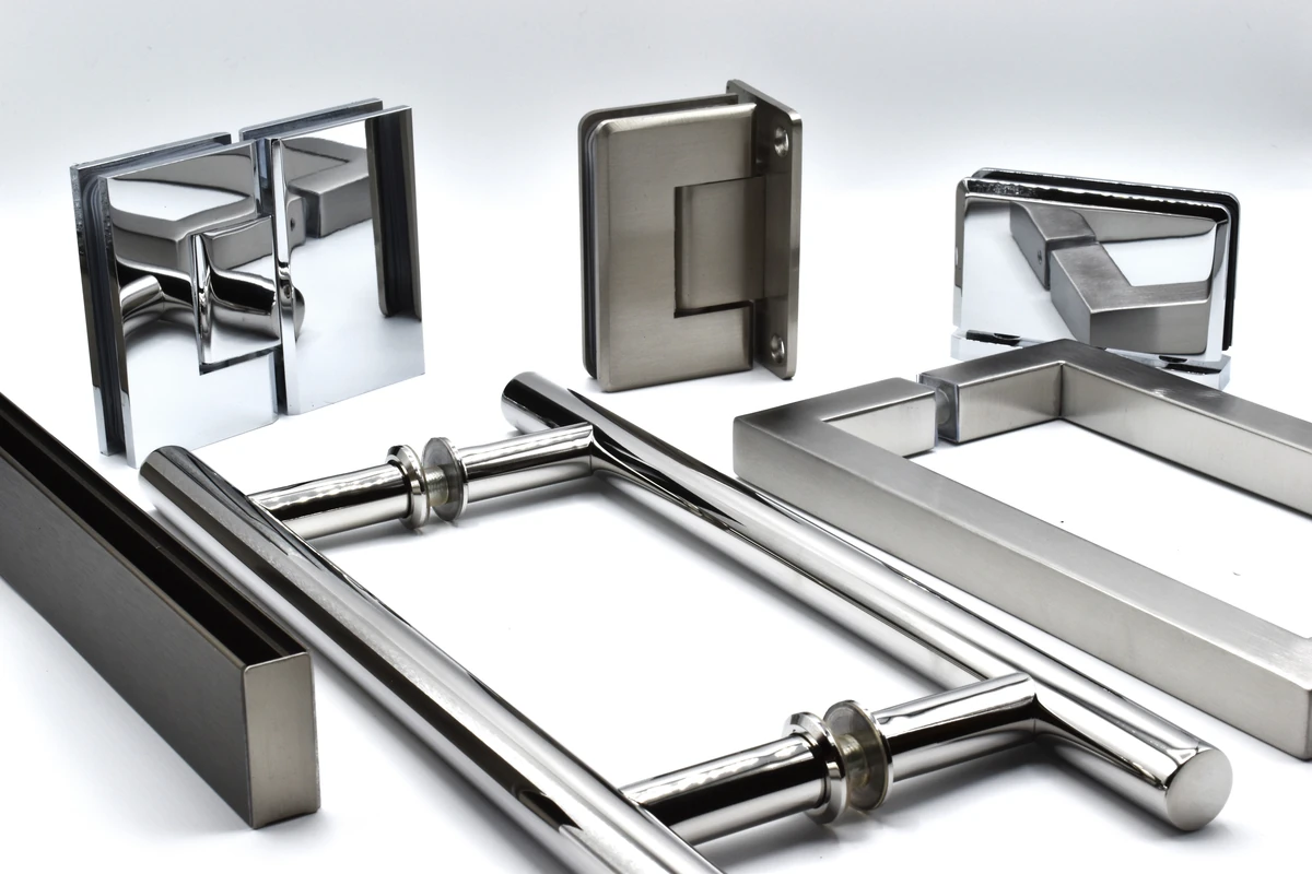 Assorted stainless steel shower door hinges, clamps, handles, and support bars